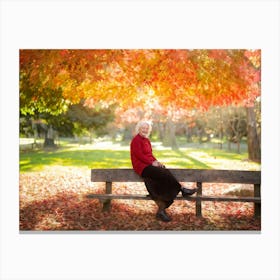 Woman Sits On A Bench In Autumn Canvas Print