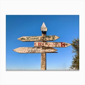 A Weathered Wooden Signpost At A Crossroad Its Arrows Pointing In Various Directions With Hand Pain (3) Canvas Print