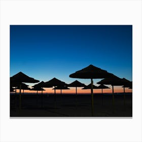 Silhouette Of Umbrellas At Sunset Canvas Print