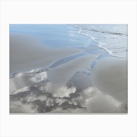 Sand, sea water and reflection of clouds Canvas Print
