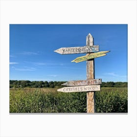 A Weathered Wooden Signpost At A Crossroad Its Arrows Pointing In Various Directions With Hand Pain (4) Canvas Print