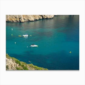 Sea water, cliffs and boats in a bay Canvas Print