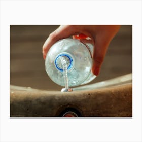 Female Hand Filling Plastic Water Bottle Canvas Print