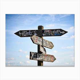 A Weathered Wooden Signpost At A Crossroad Its Arrows Pointing In Various Directions With Hand Pain (6) Canvas Print