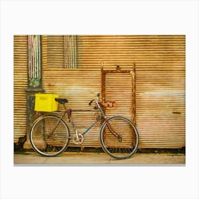 Bicycle Leaning Against Rusty Shutters Canvas Print