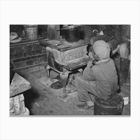 Boy Sitting By The Stove On A Cold Day In The Strawberry Picking Season, Near Independence, Louisiana By Russell Lee Canvas Print