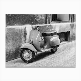 Vintage scooter parking at alley of old mediterranean town Canvas Print