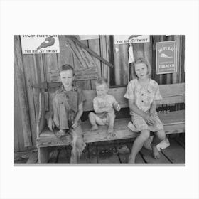 Children Of Agricultural Day Laborers Sitting On Bench In Front Of Small Store Near Vian, Oklahoma By Russell Lee Canvas Print