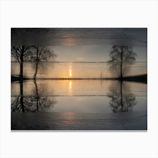 Reflection of trees in frozen water at sunset Canvas Print