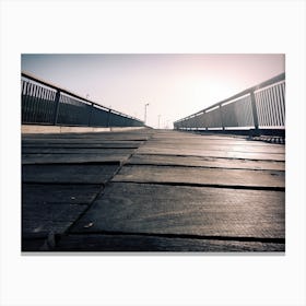 Low angle of a wooden bridge. The horizon seems endless. Sepia colors. Canvas Print