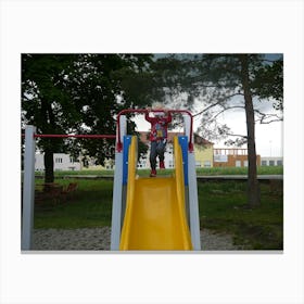 Child On A Playground Slide Canvas Print