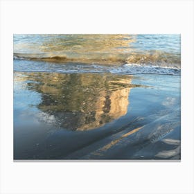 Reflection of a rock on the sandy beach Canvas Print