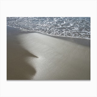 Sea water and reflections in wet sand Canvas Print