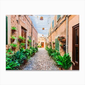 Old village Valldemossa on Mallorca, Spain Balearic islands. This romantic street is a famous landmark that depicts the rich history and Mediterranean culture of the town. The narrow alley is brimming with charming potted plants and flowers, adding to the allure of the picturesque village. Canvas Print