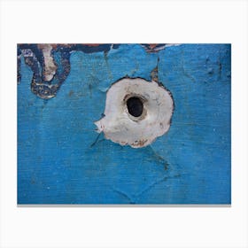 Pistol hole in the sheet metal of a car Canvas Print