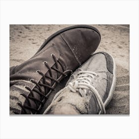 Shoes Of Man And Woman Lying Next To Each Other On The Sand Canvas Print