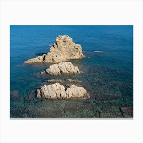 Rocks and clear blue sea water Canvas Print