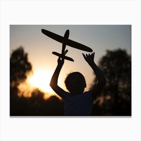 Silhouette Of A Girl Holding A Toy Plane Canvas Print