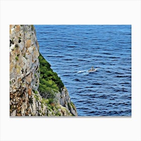 Boat on the Sea near Capo Caccia Sardinia. This image shows a view from the top of a steep, winding staircase descending between two rugged limestone cliffs toward the blue Mediterranean Sea. A small boat cruises along the calm waters in the distance, adding a sense of scale to the vastness of the sea. This scene captures the dramatic coastal landscape of Capo Caccia in Sardinia, Italy. 1 Canvas Print