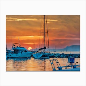 Sunset Harbor in Var Riviera. A picturesque scene of a harbor at sunset, with several sailboats docked along a rocky pier. The sky is ablaze with vibrant orange and red hues, with the sun partially obscured by clouds on the horizon. The water reflects the warm colors of the sky, creating a serene and tranquil atmosphere. The sailboats are silhouetted against the sunset, their masts reaching towards the sky. 3 Canvas Print