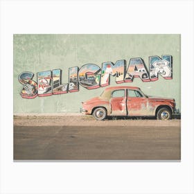 Route 66, USA I Vintage American car in front of a street art typography photography wall in Seligman in Arizona in the retro vintage american countryside during travel road trip on historic Route 66 in California Canvas Print