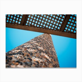 Low Angle View On Wooden Shade Of Seating Bench With Pebble Stone Column Canvas Print