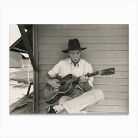 Migratory Worker Playing Guitar On Front Porch Of His Metal Shelter In The Agua Fria Labor Camp, Arizona By Russell Lee Canvas Print