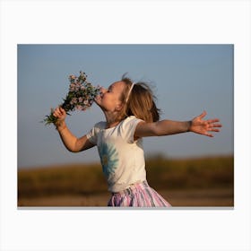 Little Girl Smelling Flowers Canvas Print