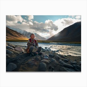 Shantiva zaga, an old tibethan woman meditating near the mountains and river Canvas Print