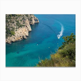 Boat arrives in a Mediterranean bay Canvas Print