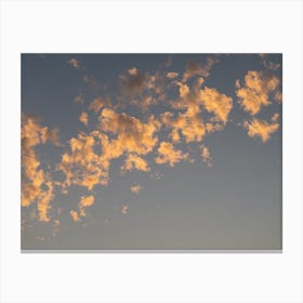 Scenic sunset clouds in pale blue sky Canvas Print