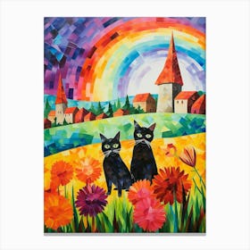 Two Black Cats With A Colourful Medieval Village In The Background Canvas Print