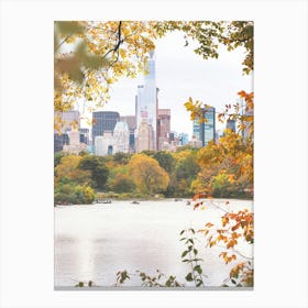 New York, USA I Central Park lake in the nature with autumn aesthetic and pastel orange tones in the wild tree leaves with the New York skyline, its skyscraper buildings and grandiose architecture photography Canvas Print