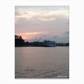 Sunset view of a river while a commercial boat passing through it Canvas Print