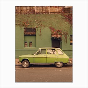 Old Green Car With Green Wall Behind Canvas Print