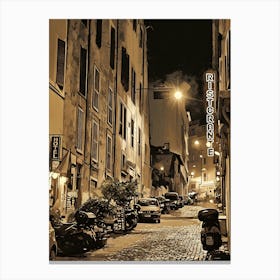 Cobblestone alleyway in an Italian city at night. The walls of the buildings lining the street are a warm, ochre color, and the windows are shuttered. The street is illuminated by a few streetlights, casting a warm glow on the scene. Canvas Print