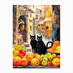 Two Black Cats With Fruit In Front Of A Town Canvas Print