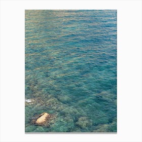 Clear sea water and reflections in a rocky bay Canvas Print