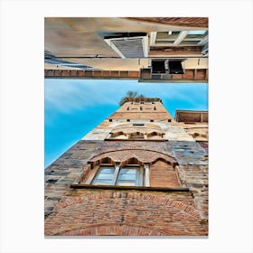 Lucca Guinigi Tower and Its Rooftop Trees. The Guinigi Tower, a historic landmark in Lucca, Italy, stands out for its unique rooftop garden featuring tall oak trees. Built in the 14th century, the red-brick structure embodies medieval architecture and offers panoramic views of the city for visitors who climb to the top. Canvas Print