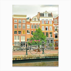 Bicycles Parked On A Bridge Overa Canal In Amsterdam Canvas Print