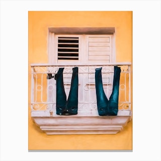 Jeans Drying From A Balcony Canvas Print
