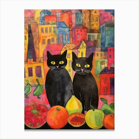 Two Black Cats With Colourful Fruit In Front Of A City Scape Canvas Print