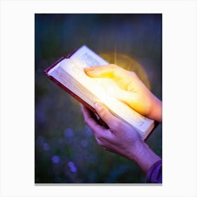 A Hand Gently Holding Open A Holy Bible To Highlight A Passage Surrounded By A Soft Glow That Sugge (2) Canvas Print