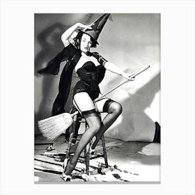 Young And Beautiful Witch Posing On A Broom In Studio Canvas Print