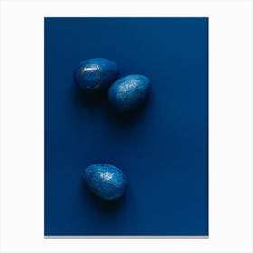 Three Blue Eggs On A Blue Surface Canvas Print