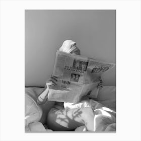 Woman Reading Newspaper In Bed Canvas Print