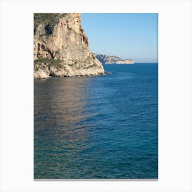 Cliffs and subtle reflections in clear sea water Canvas Print