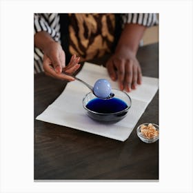 Woman Pouring Blue Liquid Into A Bowl Canvas Print