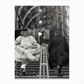Couple Running Up Steps In Big Coats Black And White Canvas Print