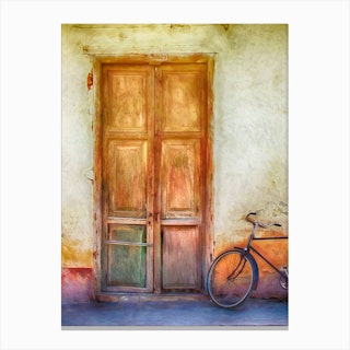 Bicycle By Weatherd Door Canvas Print